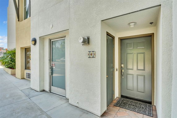 Front view of a building entrance with a gray door and number 401.