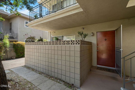 Front view of an apartment building with a small patio area.