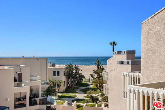 View of oceanfront buildings with balconies overlooking the beach.