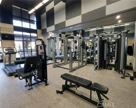 Indoor gym area with exercise equipment and weight machines.