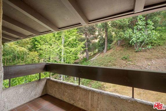 View of surrounding greenery from a covered balcony.
