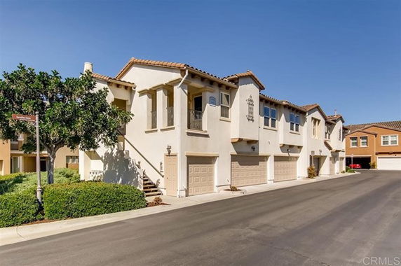 Front view of a two-story townhouse with garages at the ground level.
