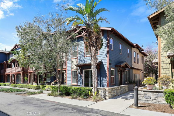 Front view of a two-story house with blue siding and wooden accents.