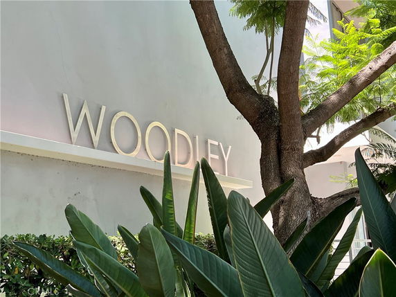 Front view of a building with the name 'WOODLEY' displayed on the wall.