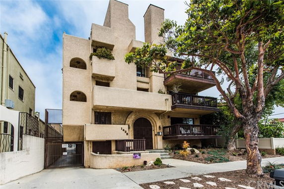 Front view of a multi-story residential building with balconies.