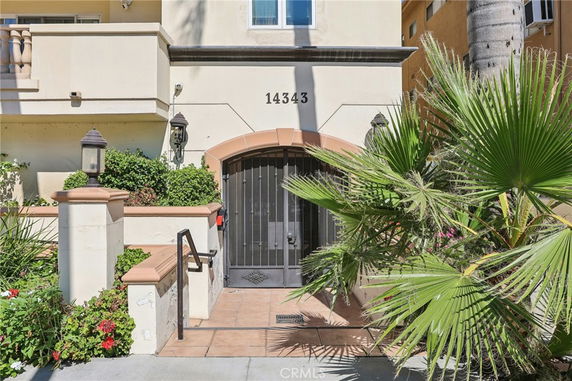 Front view of a building entrance with an ornate gate and address number 14343.