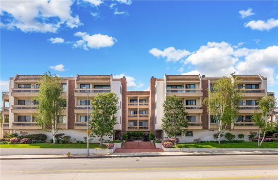 Front view of a multi-story residential building with balconies.