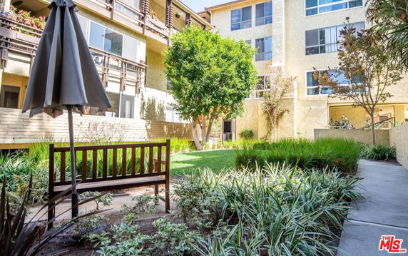Outdoor view of a multi-story residential building with garden area.