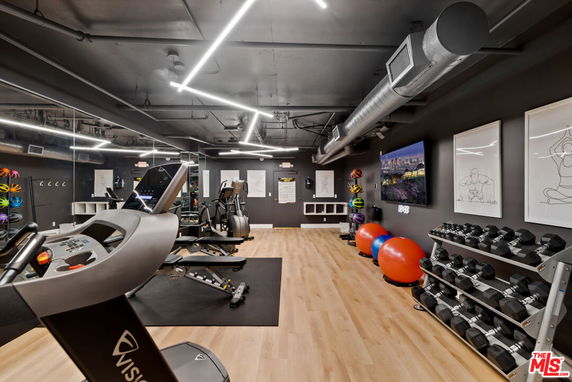 Indoor gym with fitness equipment and exercise area.