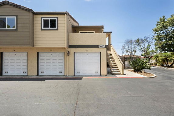 Front view of a two-story building with multiple garages.