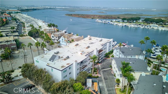 Panoramic view of buildings near a waterfront with boats docked.