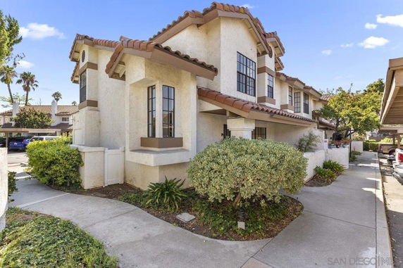 Front view of a two-story house with a tiled roof and white exterior.