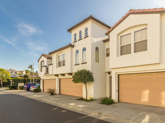 Front view of a multi-story house with attached garages.