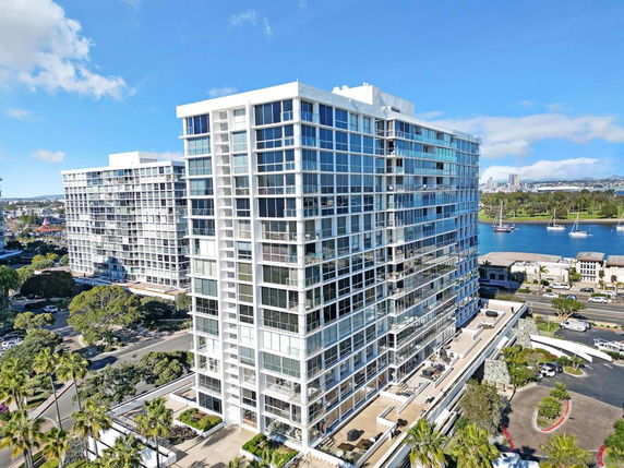 Front view of a modern high-rise building with glass façade.