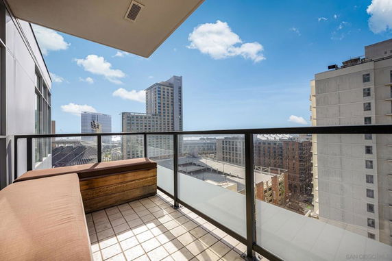 Balcony view overlooking a cityscape with tall buildings.