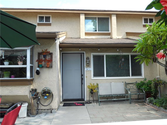 Front view of a house with a single entrance door and large window.