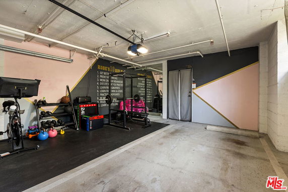 Indoor gym area with exercise equipment and motivational wall.