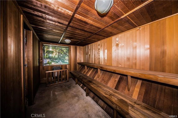 Interior view of a wooden sauna room with benches.