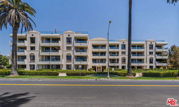 Front view of a multi-story residential building with balconies.
