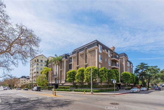 Front view of a multi-story apartment building with balconies.