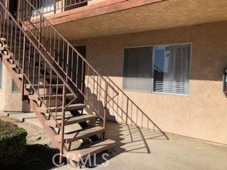 Front view of a building with external staircase and window.