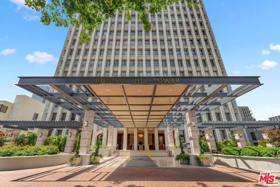 Front view of a high-rise building entrance with large canopy and signage reading Bunker Hill Tower.