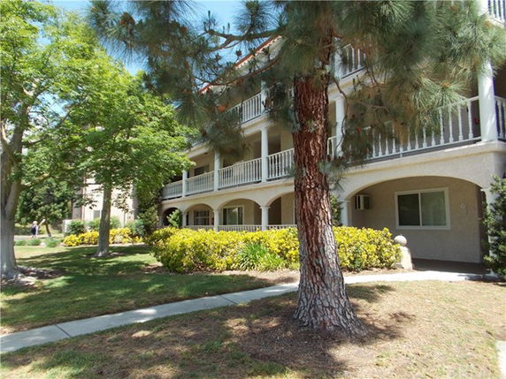 Front view of a two-story building with balconies and a walkway.