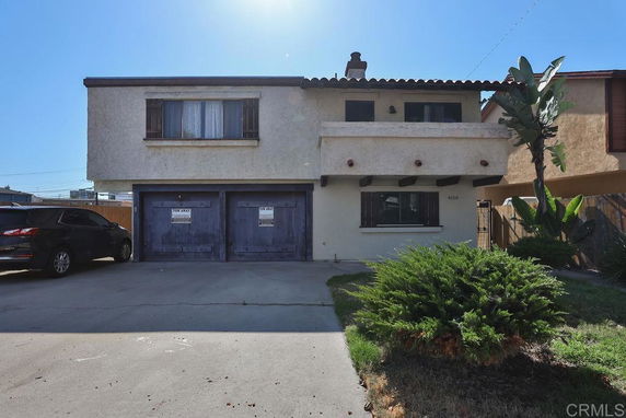 Front view of a two-story house with a double garage.