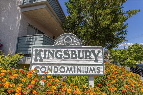 Front view of a condominium building with a sign reading 'Kingsbury Condominiums'