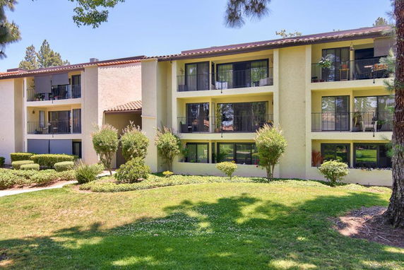 Front view of a multi-story residential building with balconies.