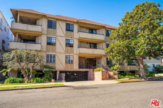 Front view of a multi-story residential building with balconies.