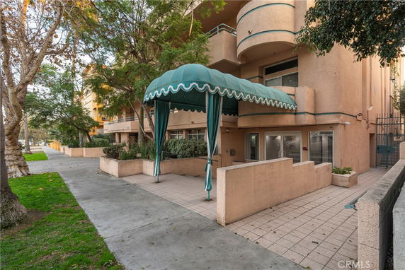 Front view of a multi-story building with a green canopy entrance.