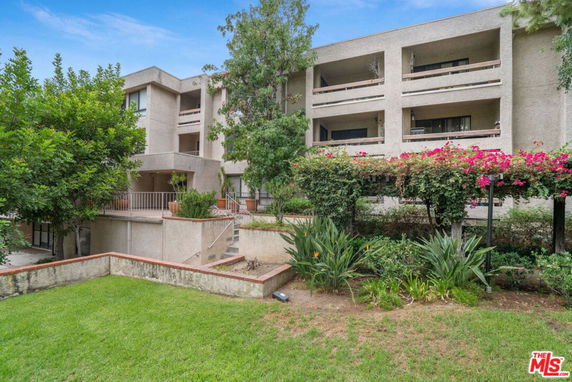 Front view of a multi-story residential building with balconies.
