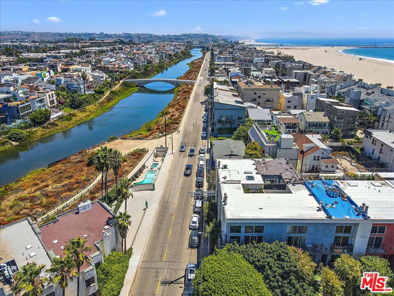 Panoramic view of coastal neighborhood with river and beach