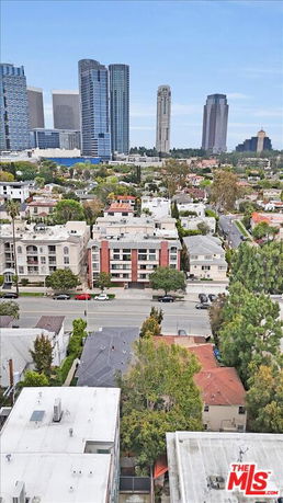 Panoramic view of cityscape with tall buildings and residential area.