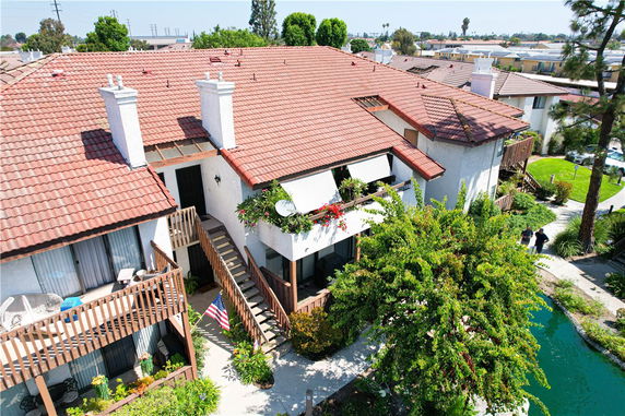 Front view of a house with a red-tiled roof and outdoor staircases.