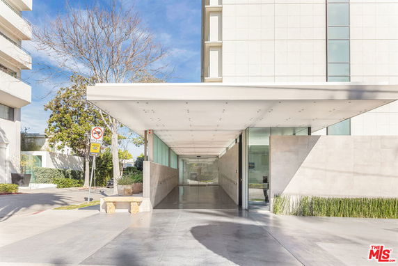 Front view of a modern building with a sleek entrance canopy.