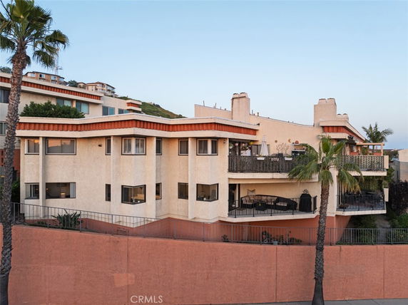 Front view of a multi-story residential building with balconies.