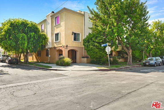 Front view of a multi-story building on a street corner.