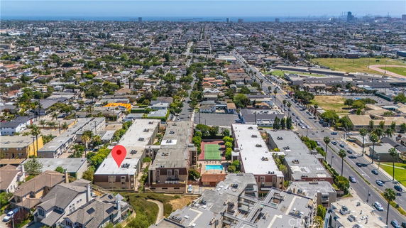 Panoramic view of a city with multiple buildings and a view of the ocean in the distance.