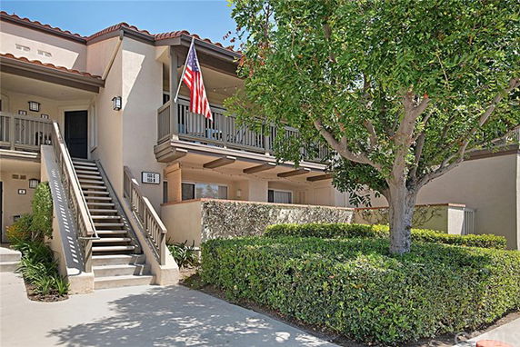 Front view of a two-story building with an exterior staircase and balconies.