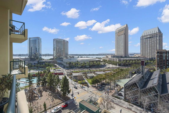 Panoramic view of a cityscape featuring modern skyscrapers and a waterfront.