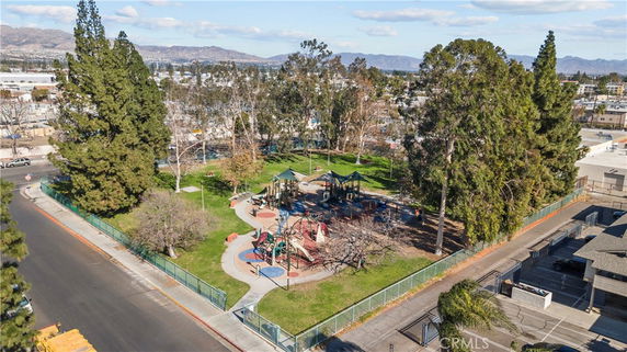 Aerial view of an outdoor playground with play structures and surrounding trees.