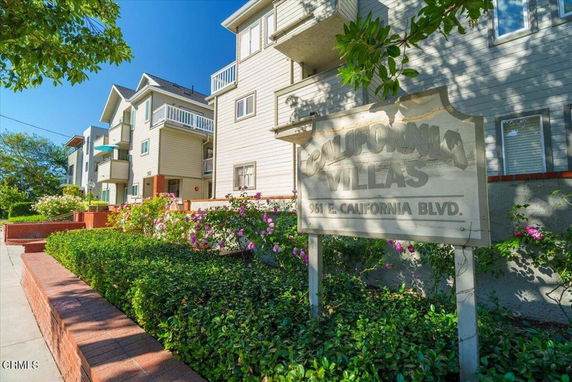 Front view of a multi-story building with balconies and a sign for California Villas.