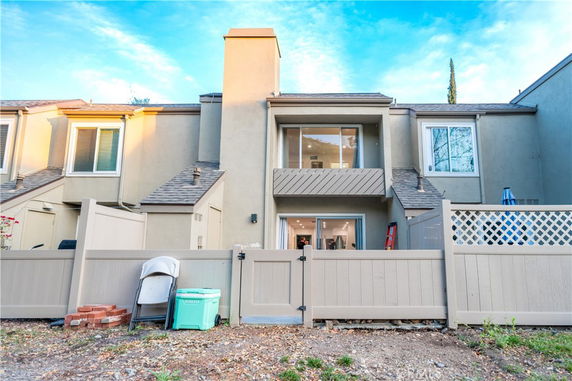 Front view of a two-story house with a fenced yard.