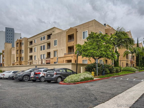 Front view of a multi-story apartment building with balconies.