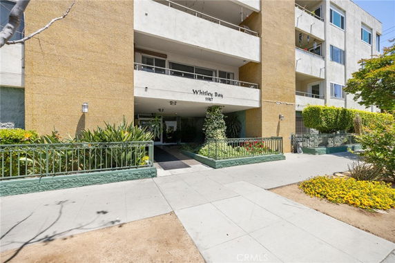 Front view of a multi-story residential building with balconies.