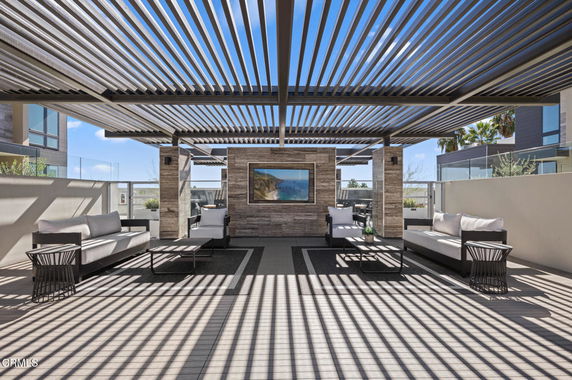 Rooftop area with modern seating and pergola with slatted design