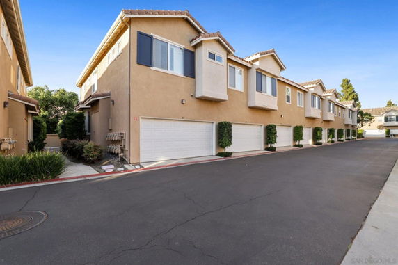 Front view of a row of townhouses with double garages.