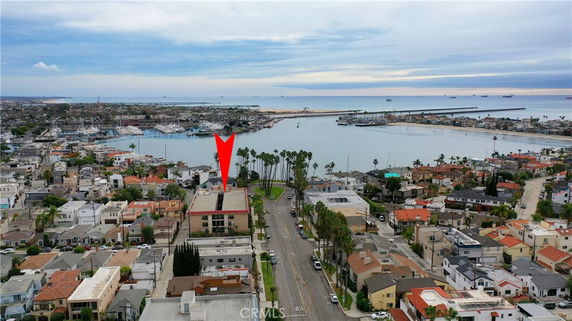 Panoramic view of a coastal residential area with ocean and marina.